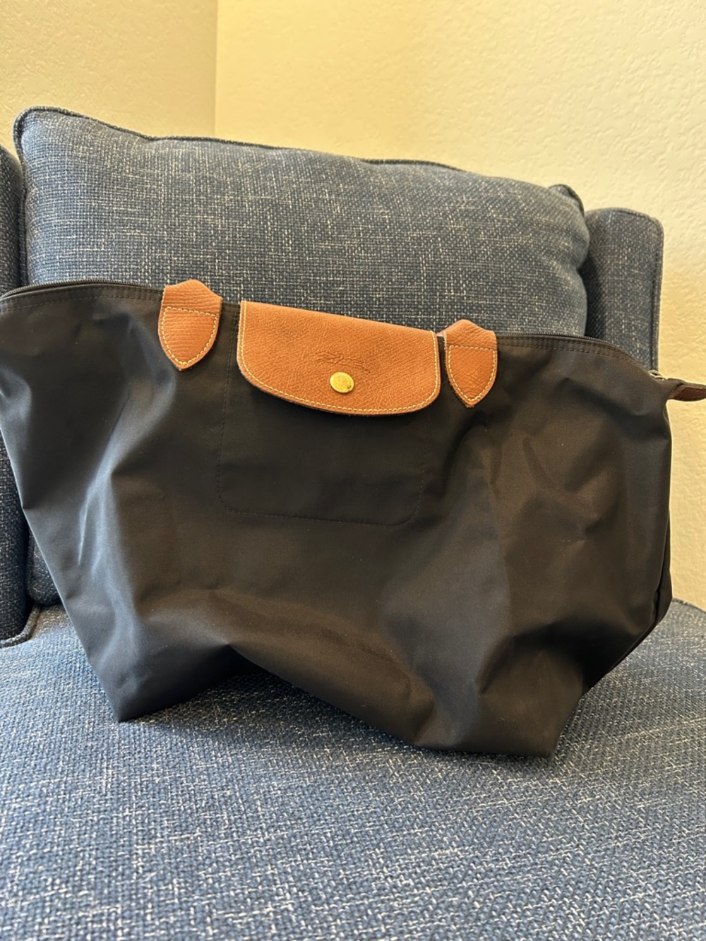 Longchamp black nylon tote with brown leather trim.  Medium, classic Le Pliage!
